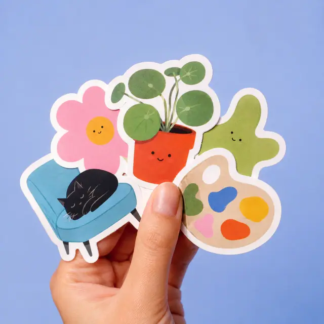 Mano sosteniendo una colección original de stickers troquelados
